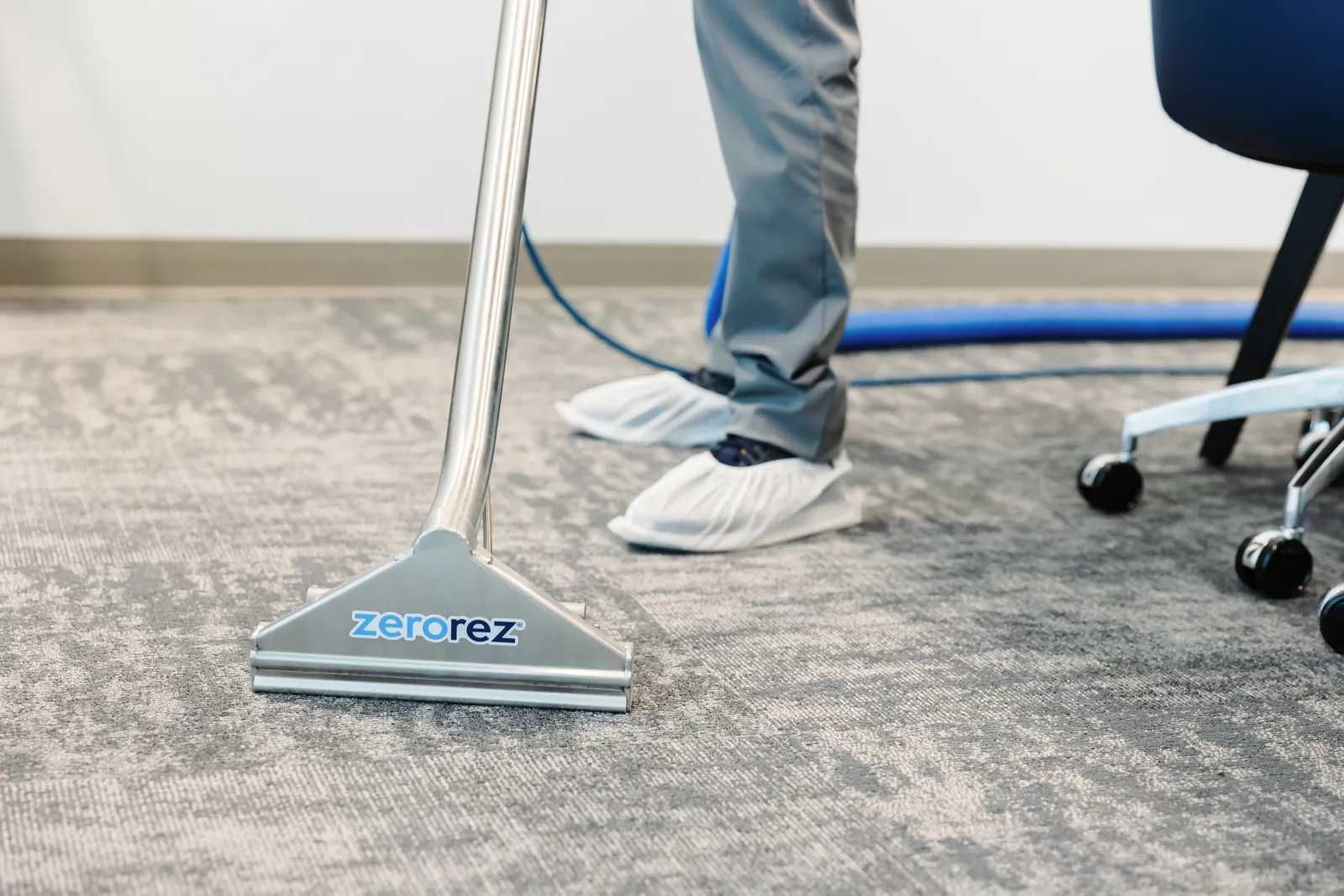 carpet cleaning with steam cleaning wand on gray carpet