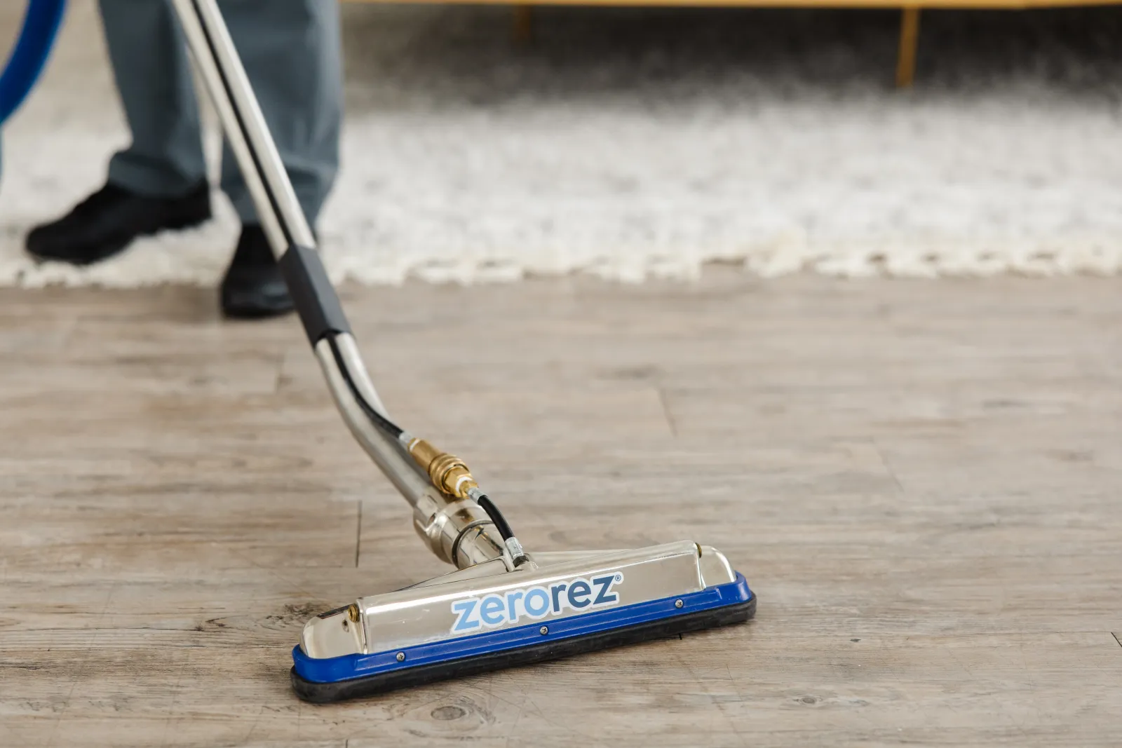 Zerorez cleaning wand on a laminate floor, being used to clean it