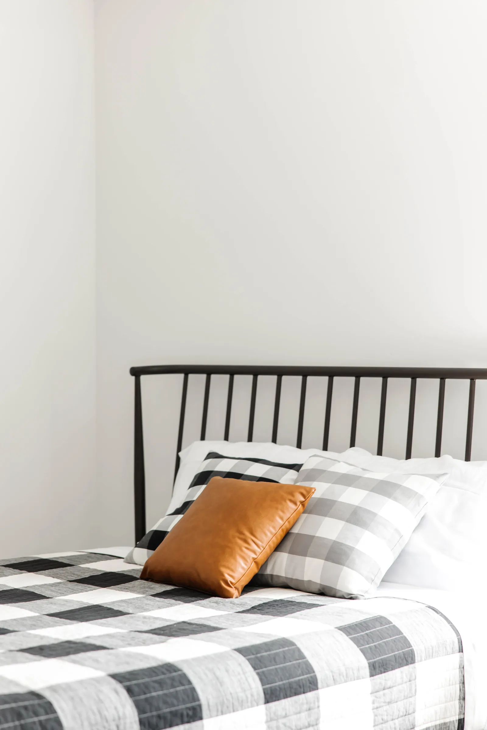 checkered bed with white blanket and mattress