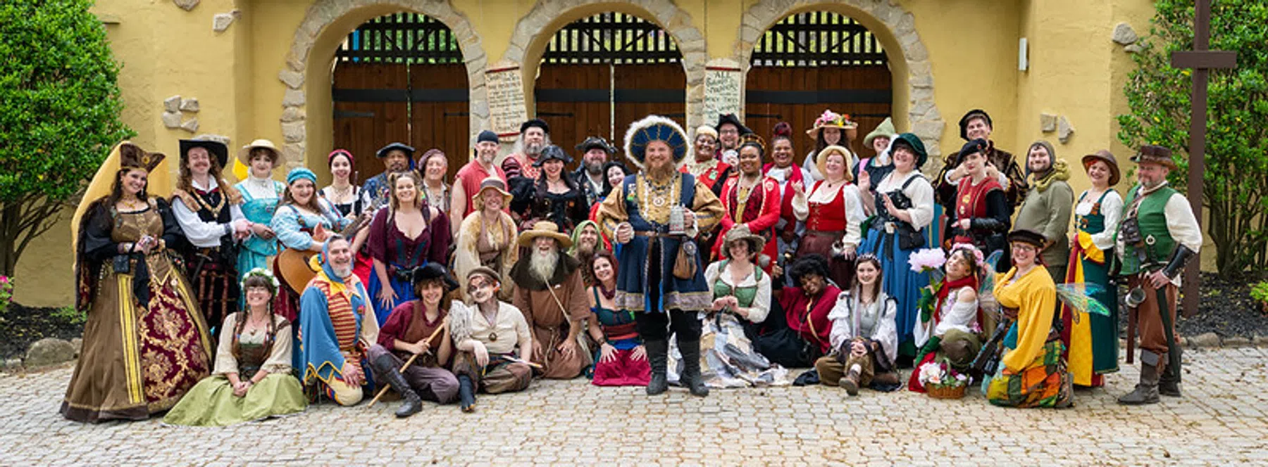 The full Festival street cast in costume gathered at the front gate.