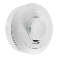 White round smoke detector sensor with a central test or control button and ventilation slots