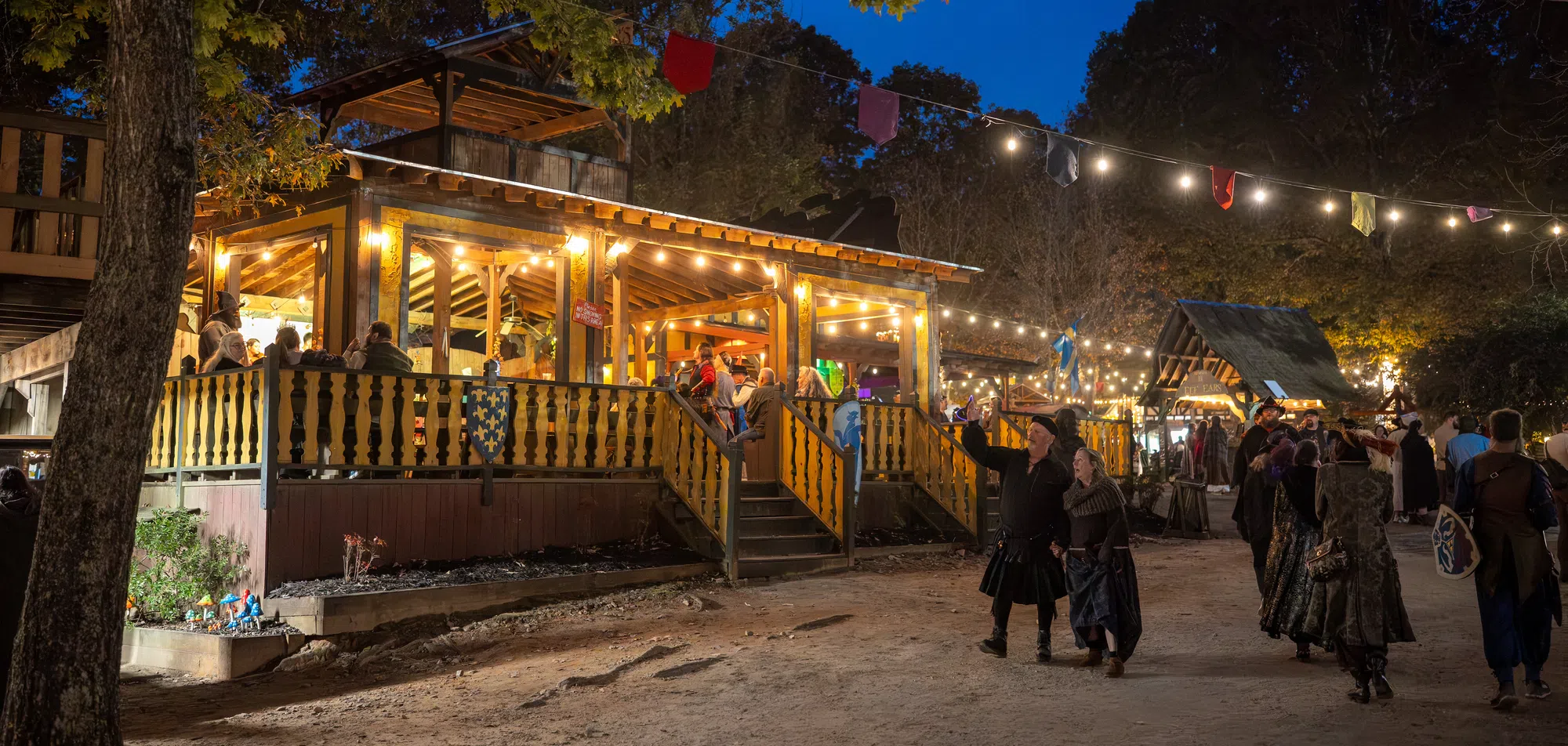 A lantern-lit pub in the Renaissance village on a Fall Fling evening