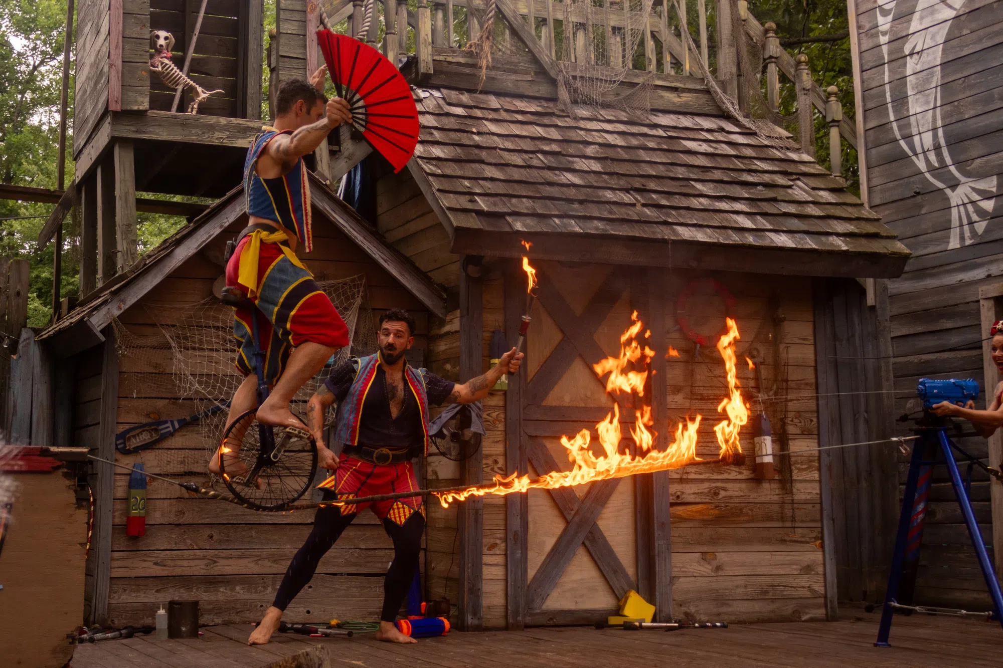 A performer crossing a flaming tightrope before a crowd at Georgia Renaissance Festival