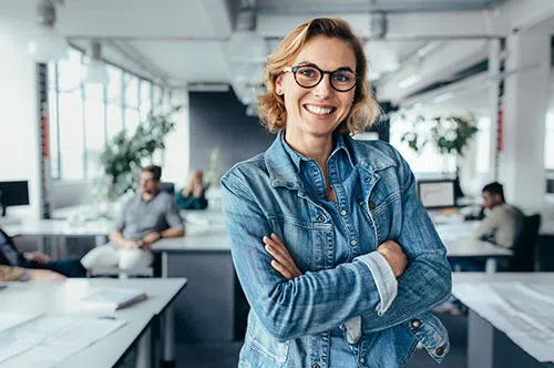Smiling woman with glasses and denim jacket