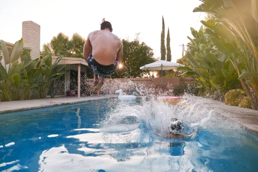 a man jumping into a pool
