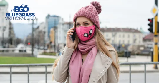 a woman wearing a hat talking on a cell phone