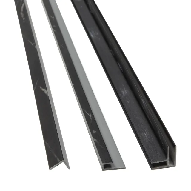 Three black and gray marble-patterned plastic trim strips with different profiles isolated on white.