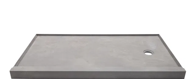 Rectangular gray concrete shower base with drain hole on white background