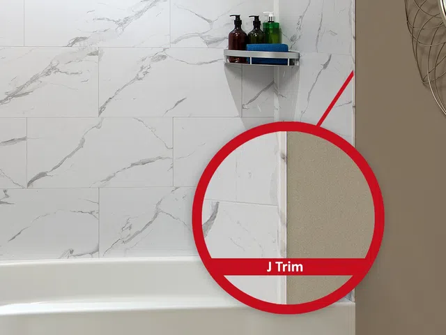 Close-up of bathroom corner with marble wall tiles, bathtub edge, and J trim detail highlighted in red circle