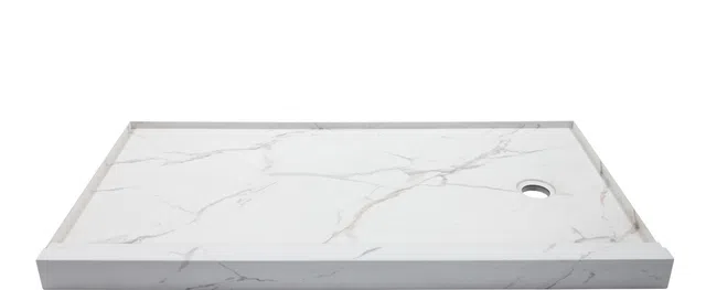 White marble shower base with subtle gray veining and a round drain hole on the right side