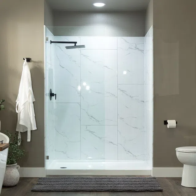 Modern bathroom with glass shower enclosure, marble tiles, black showerhead, gray rug, and beige walls.