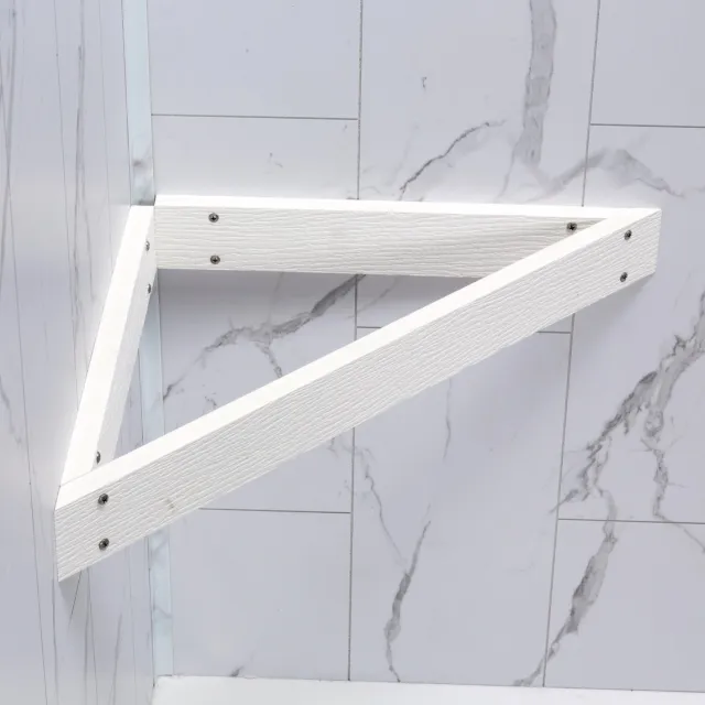 White triangular wooden shelf bracket mounted on a marble tile wall with gray veining.