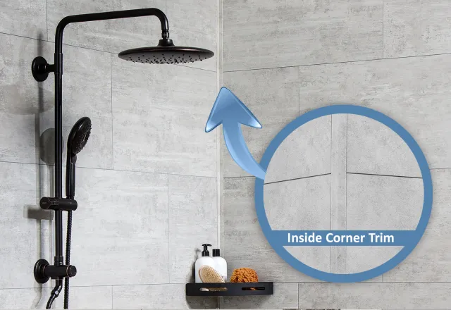 Black showerhead and hand shower mounted on gray tiled wall with inside corner trim detail highlighted