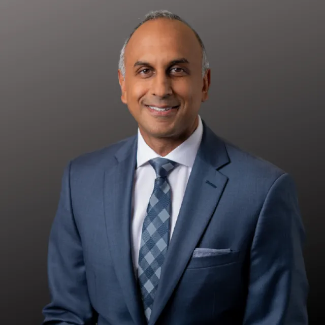 a man in a suit smiling
