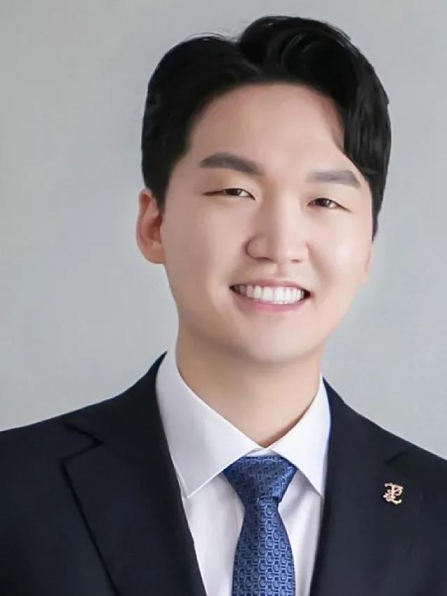a boy wearing a suit and tie