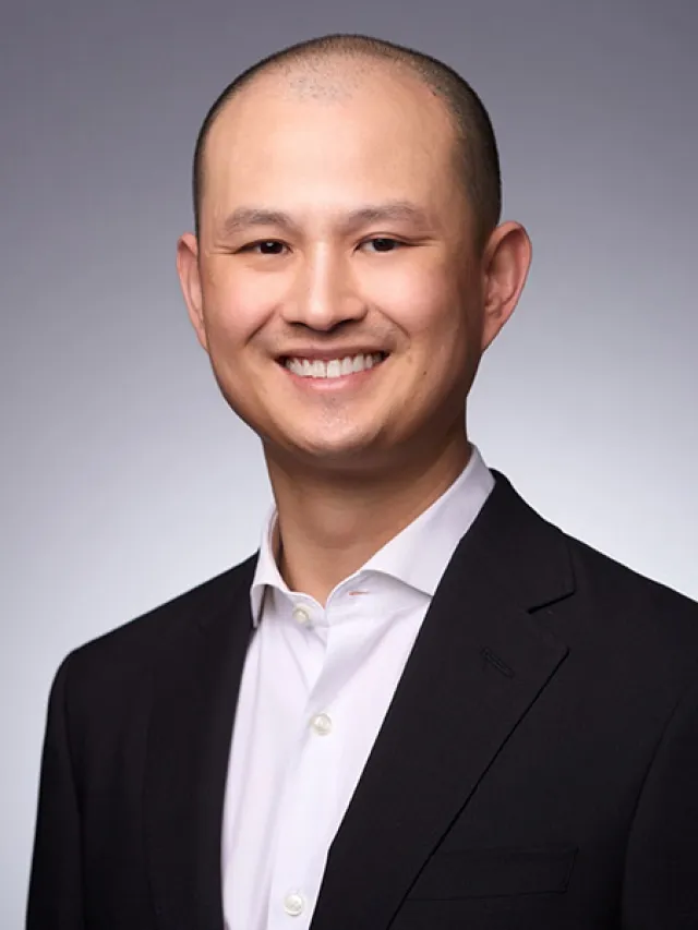 a man in a suit smiling