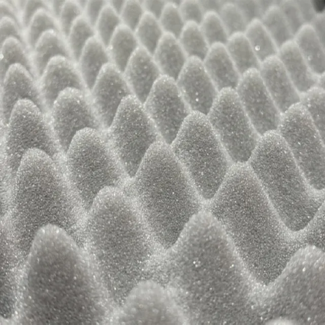 Close-up of a gray egg crate foam surface with textured peaks and valleys for cushioning