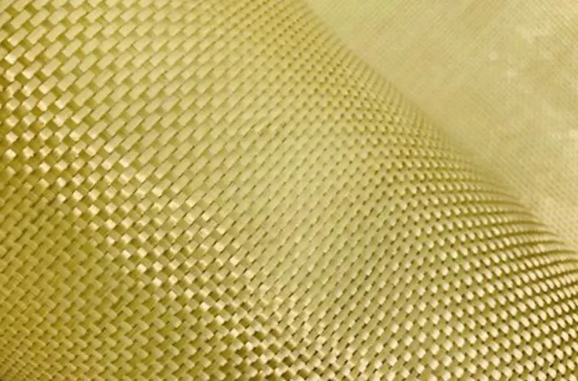 Close-up of yellow woven fabric with detailed texture and pattern, showing tightly interlaced fibers.