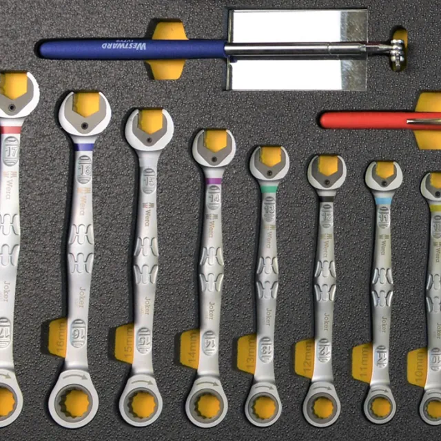Set of tube fitting tools with handles, a Tube Fitter's Manual, and various metal connectors in a black foam case.
