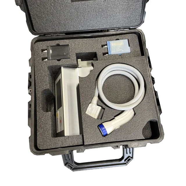 Portable medical device kit with coiled cable and control unit neatly arranged in protective foam case.