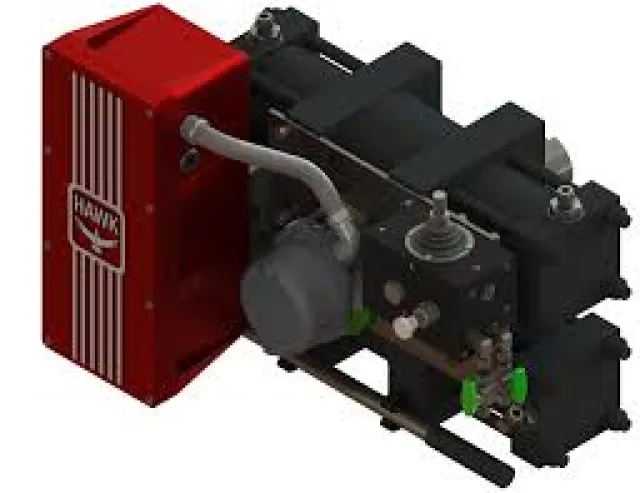 Red and black industrial mechanical device with attached pipes and control components on a white background