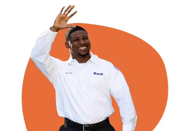 Technician in a white Bardi uniform waving with an orange abstract background