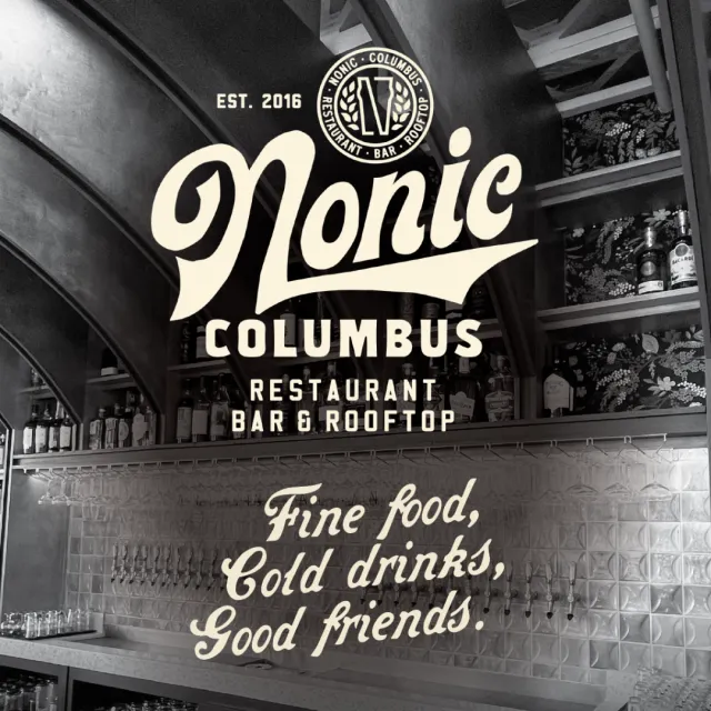 Nonic Columbus restaurant bar rooftop logo and slogan on black and white bar interior photo