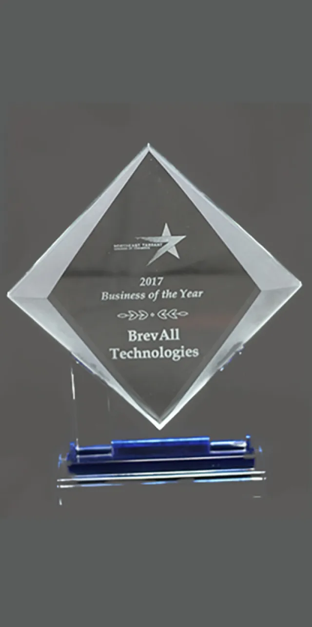 2017 Business of the Year award trophy presented to BrevAll Technologies with a star emblem on a glass plaque.