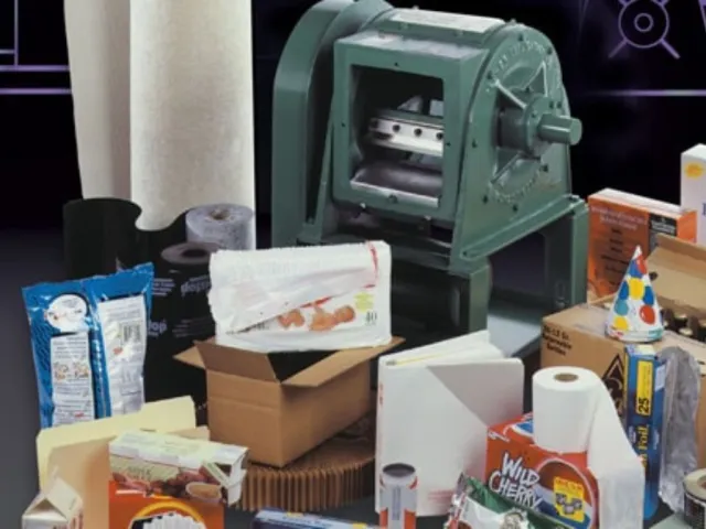 Packaging supplies and equipment including boxes, bags, rolls, and a green industrial machine.
