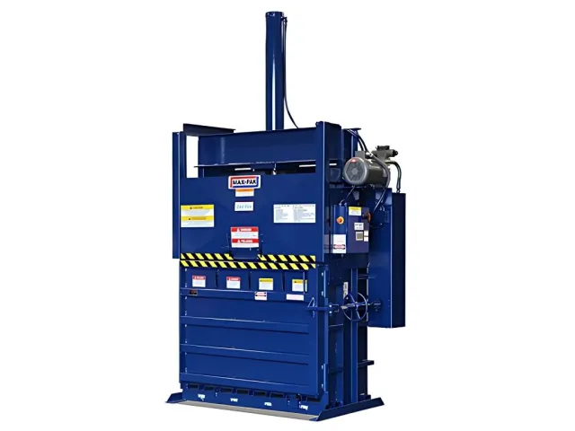 Industrial blue vertical baler machine with warning labels and control panel isolated on white background