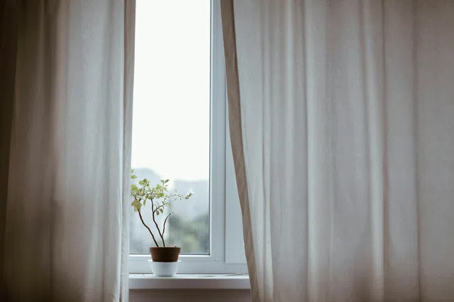 Motorized draperies opening on a wide window