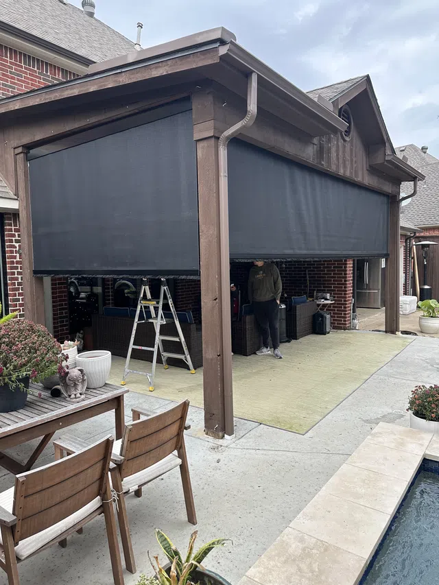 Exterior patio shades lowered over an outdoor space