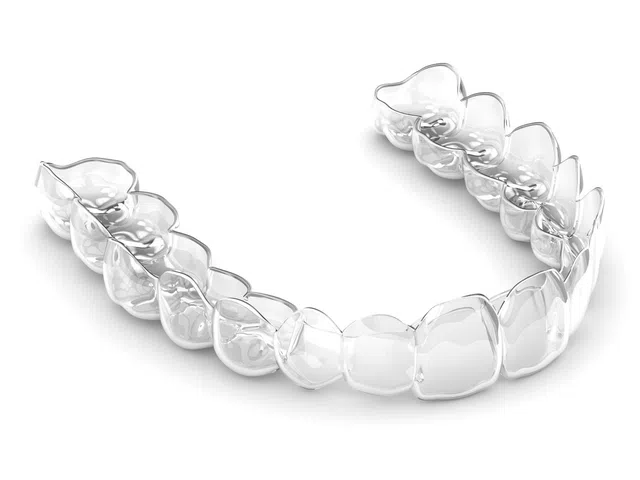 Clear transparent dental aligner for straightening teeth shown on white background.