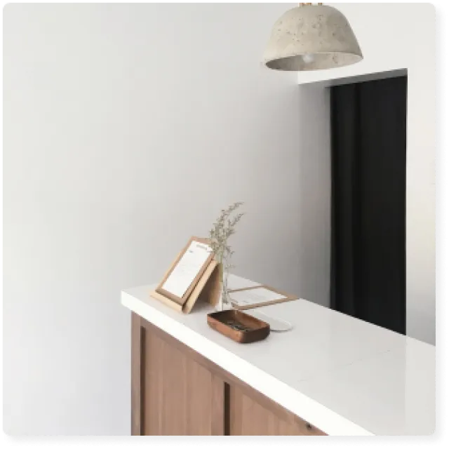 a desk with a lamp and a book on it