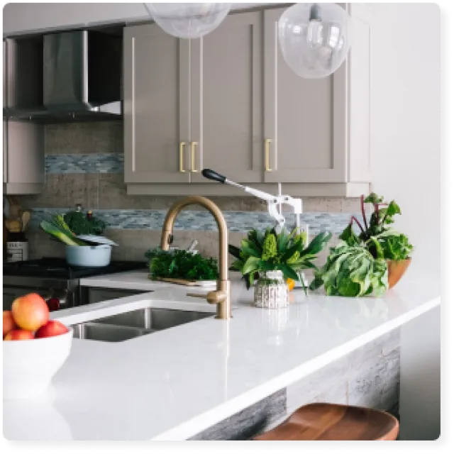 a kitchen with white cabinets and a sink