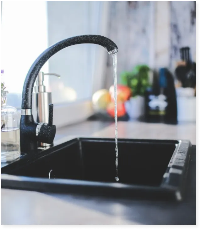 a faucet pouring water into a sink