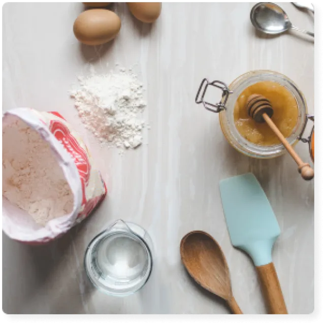 a table with a cake and spoon