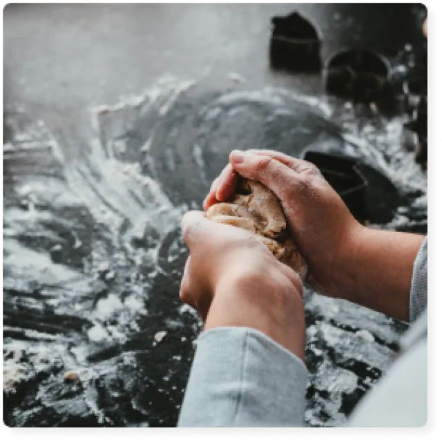 a person kneading dough