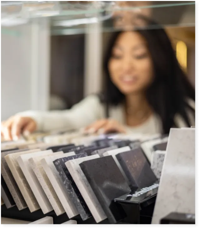 a woman looking through stone samples