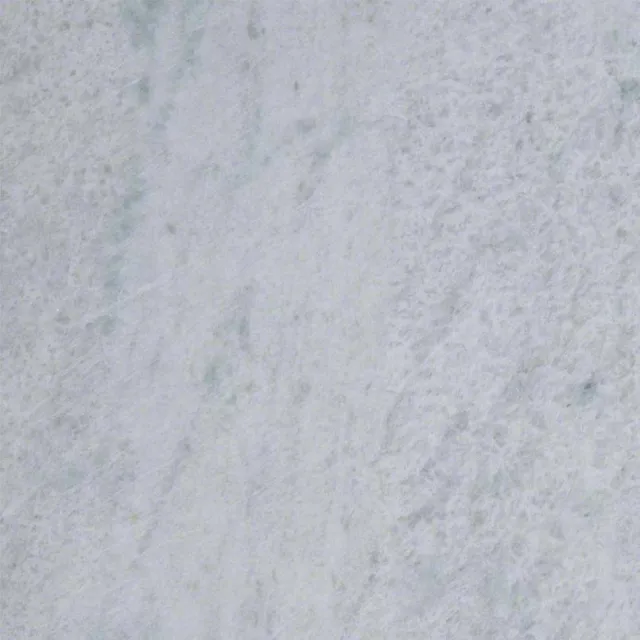 a white surface with a dark speckled surface