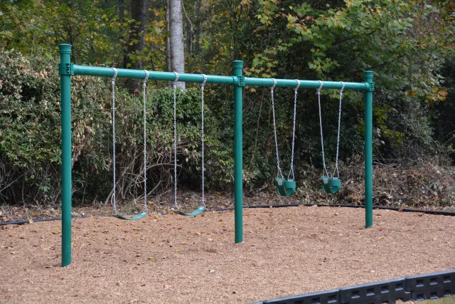 a playground with green poles