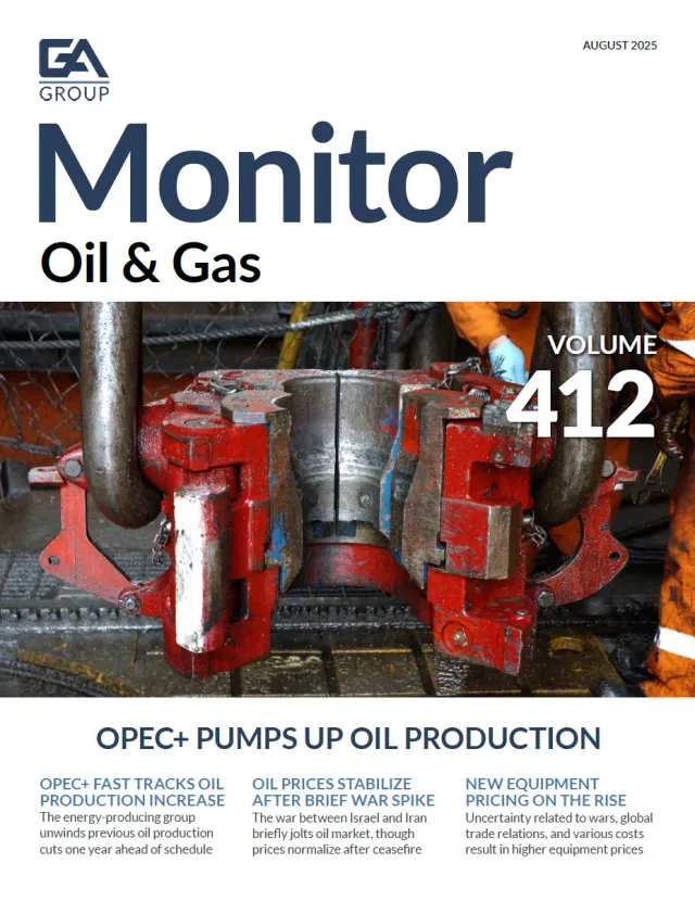 Close-up of industrial red oil drilling equipment with workers in orange safety gear during operation.