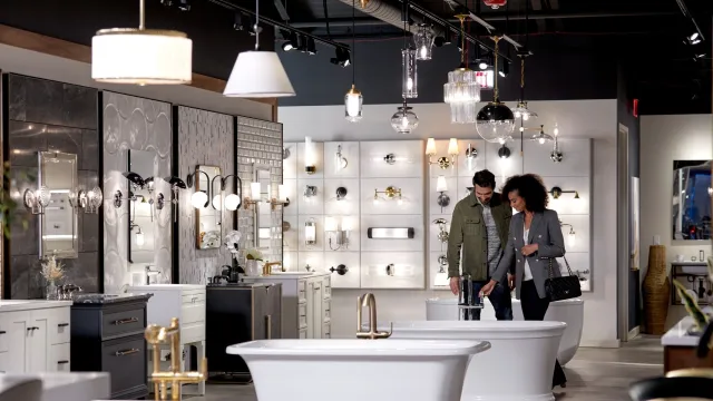 Stylish bathroom showroom featuring elegant tubs, lighting, and modern fixtures.