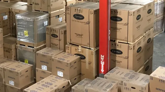 A spacious warehouse filled with neatly stacked cardboard boxes and organized inventory.