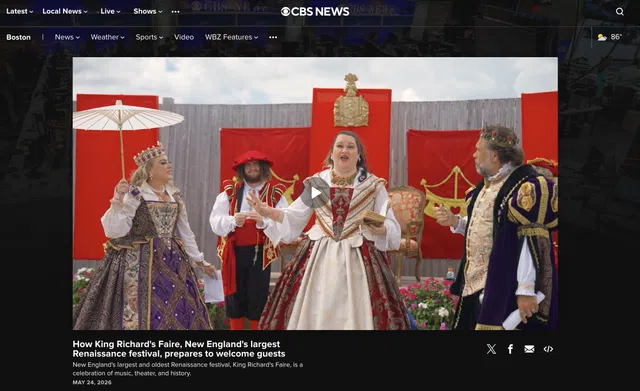 Actors in elaborate Renaissance costumes perform at King Richard's Faire with red and gold stage backdrop outdoors.