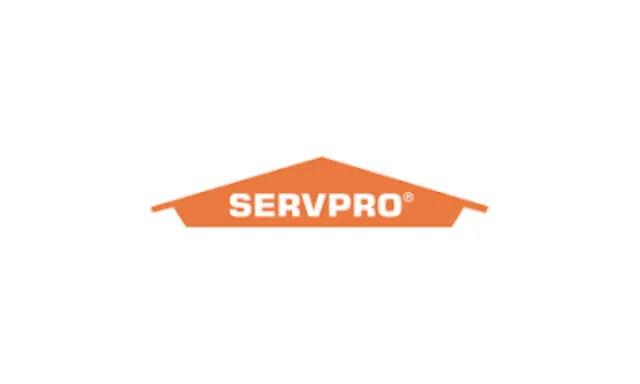 SERVPRO logo featuring white text inside an orange house-shaped roof on a white background