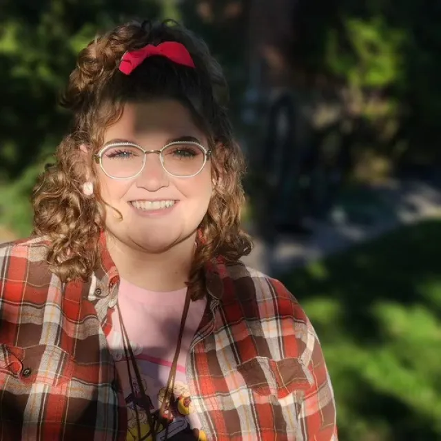 a person with glasses smiling