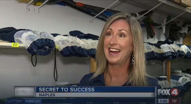 Michelle Spitzer smiling in front of a closet full of clothes