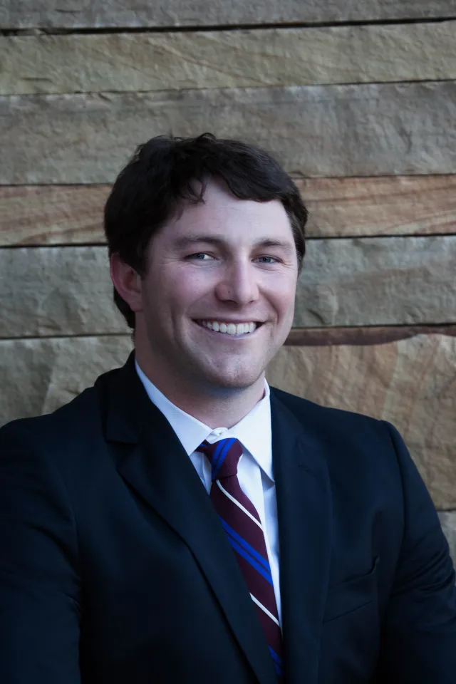 a man in a suit smiling