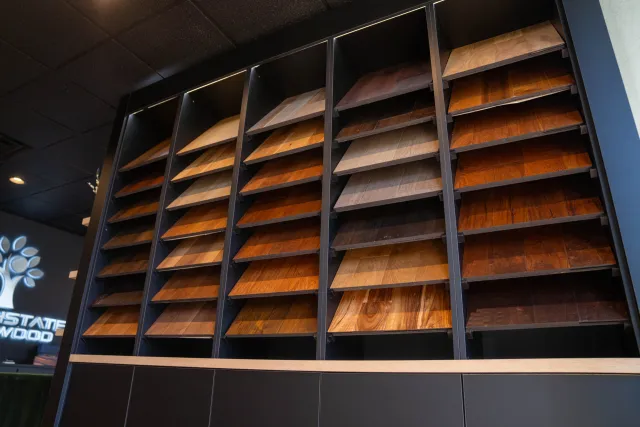 Display of various wooden veneer samples in a showroom with different colors and wood grains.